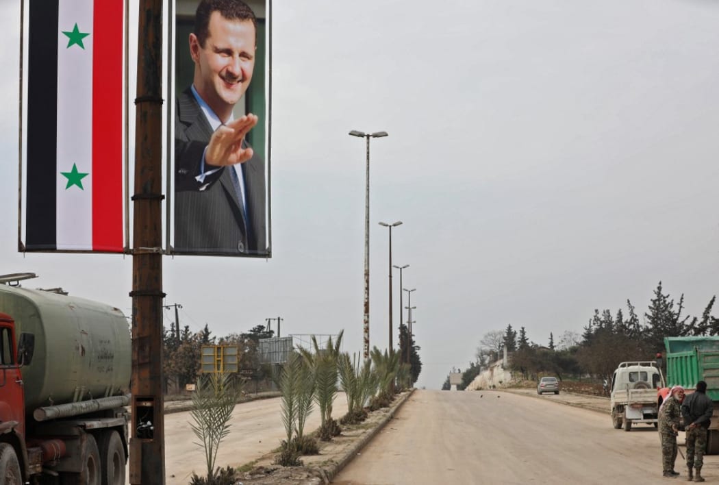 A poster of Syrian President Bashar al-Assad adorning the M5 highway connecting Aleppo to Damascus on February 18, 2020.