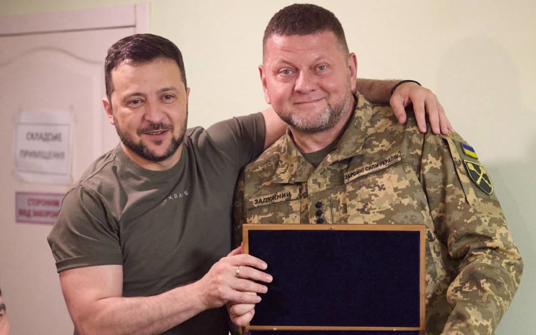 This handout photograph released on July 27, 2023, by the Ukrainian Presidential press-service at an undisclosed location, shows Ukrainian President Volodymyr Zelensky rewarding Ukraine's military commander-in-chief Valery Zaluzhny with a pistol on the occasion of his birthday. (Photo by Handout / UKRAINIAN PRESIDENTIAL PRESS SERVICE / AFP) / RESTRICTED TO EDITORIAL USE - MANDATORY CREDIT "AFP PHOTO / UKRAINIAN PRESIDENTIAL PRESS SERVICE  " - NO MARKETING NO ADVERTISING CAMPAIGNS - DISTRIBUTED AS A SERVICE TO CLIENTS