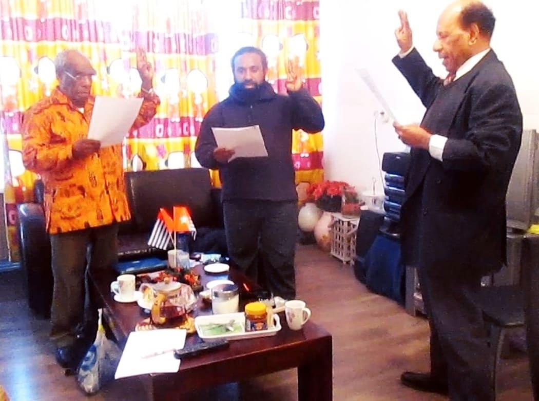 Jeffrey Bomanak (middle) takes oath with a Free Papua Movement (OPM) leader Jacob Prai (right) in Sweden in 2017.