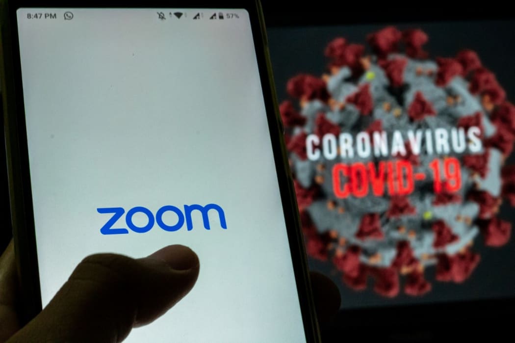 Logo of Zoom, video conferencing application services company is seen with the text of coronavirus COVID-19 in the back of it in Yogyakarta, Indonesia on April 3, 2020. Zoom video conferencing application is used to have a group chat from their separate homes, due to the coronavirus COVID-19.