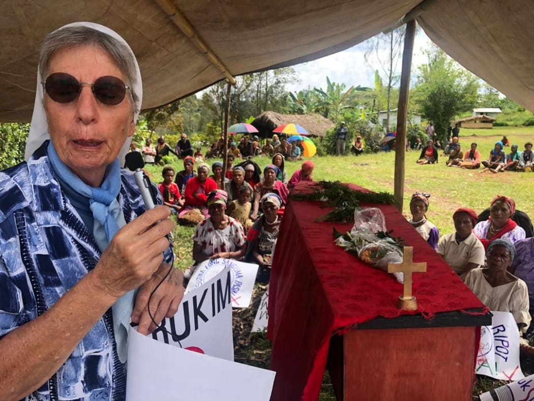 Sister Lorena Jenal speaks at a funeral for a victim of a sorcery accusation-related attack.