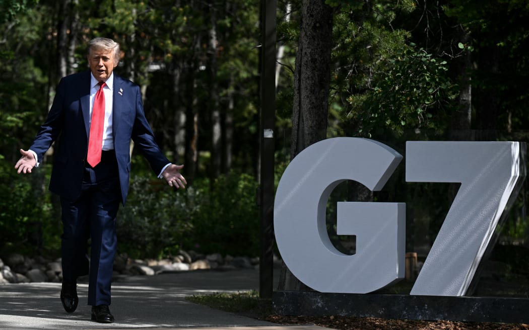 US President Donald Trump gestures during an arrival ceremony at the Group of Seven (G7) Summit at the Pomeroy Kananaskis Mountain Lodge in Kananaskis, Alberta, Canada on June 16, 2025. (Photo by Brendan SMIALOWSKI / AFP)