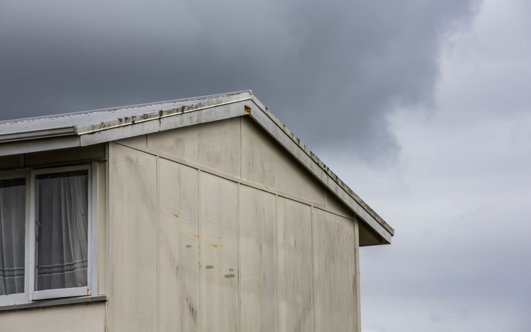 A state house with dark clouds above it