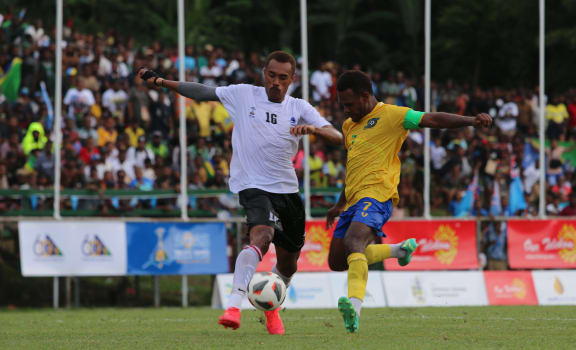 Pacific Games football semi-finals: Solomon Islands captain Micah Lea’alafa (right) attempts a shot at goal under the close supervision of Fiji’s Gabiriele Matanisiga. A Lea’alafa goal sealed Solomon Islands 2-0 victory over Fiji setting up a grand final with New Caledonia. Lawson Tama Stadium, Honiara 28 November 2023