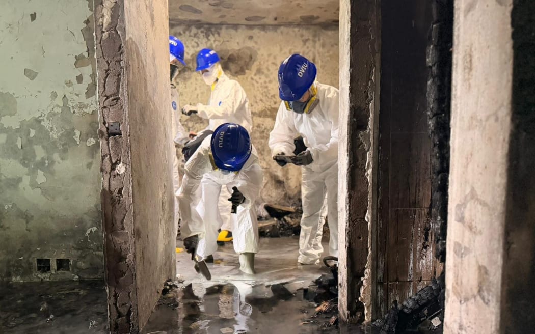 Specialist police search the apartments in Wang Fuk Court complex on Sunday