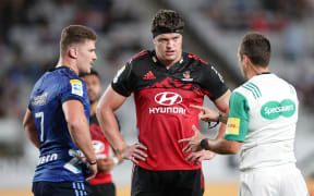 Blues captain Dalton Papali'i and Crusaders captain Scott Barrett listen to the referee