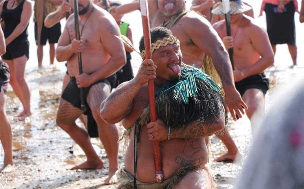 A mass haka breaks out on the beach.