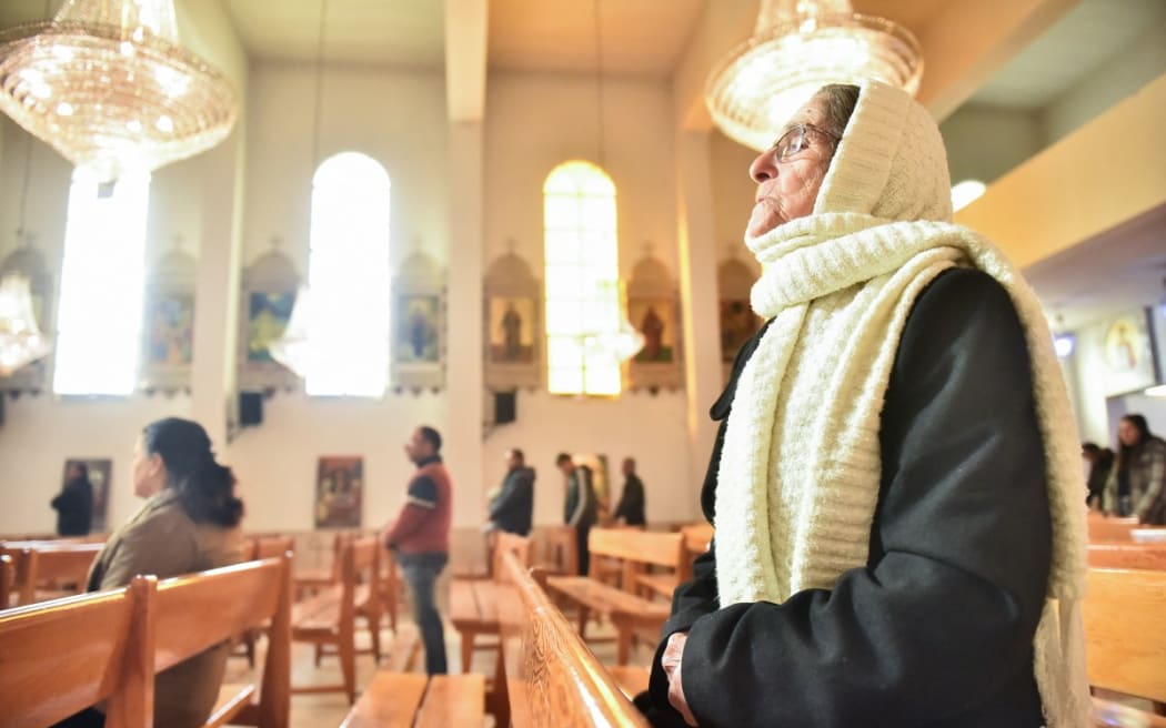 Worshippers attend Sunday Mass at a church in the village of Maalula north of the Syrian capital Damascus on 15 December, 2024.
