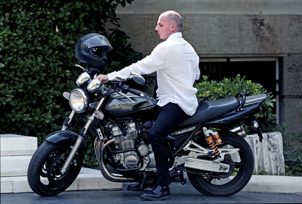Greek Finance Minister Yanis Varoufakis arrives on his motorcycle for a cabinet meeting at the Prime Minister's office in Athens.