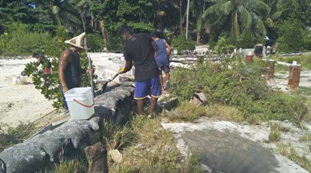 Youths on South Tarawa rebuilding seawalls at low tide, 30 August 2019