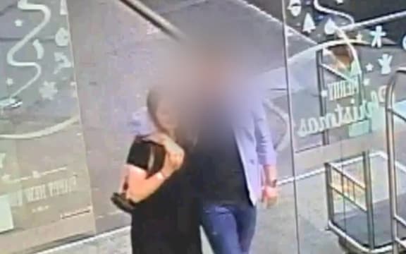 The defendant and Grace Millane hug when meeting for the first time at the base of the Sky Tower in Auckland.