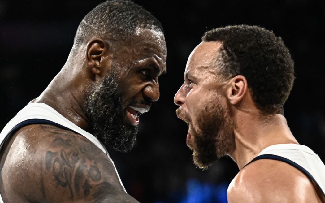 LeBron James (L) and Steph Curry celebrate the United States' Olympic men's basketball semi-final win over Serbia.