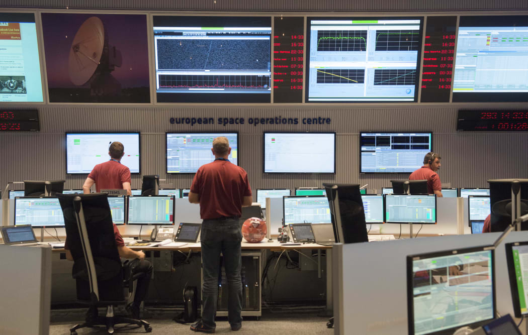 Engineers stand in the main control room of the European Space Agency prior to the expected landing of Schiaparelli.