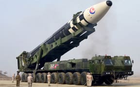 This picture taken on March 24, 2022 and released from Korean Central News Agency on March 25, 2022 shows what state media reports as a new type inter-continental ballistic missile (ICBM), the Hwasongpho-17 in an undisclosed location in North Korea.