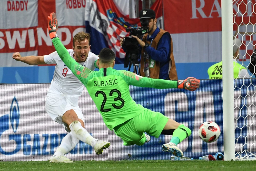 England's forward Harry Kane (L) attempts to score past Croatia's goalkeeper Danijel Subasic during the Russia 2018 World Cup semi-final football match between Croatia and England at the Luzhniki Stadium in Moscow on July 11, 2018.