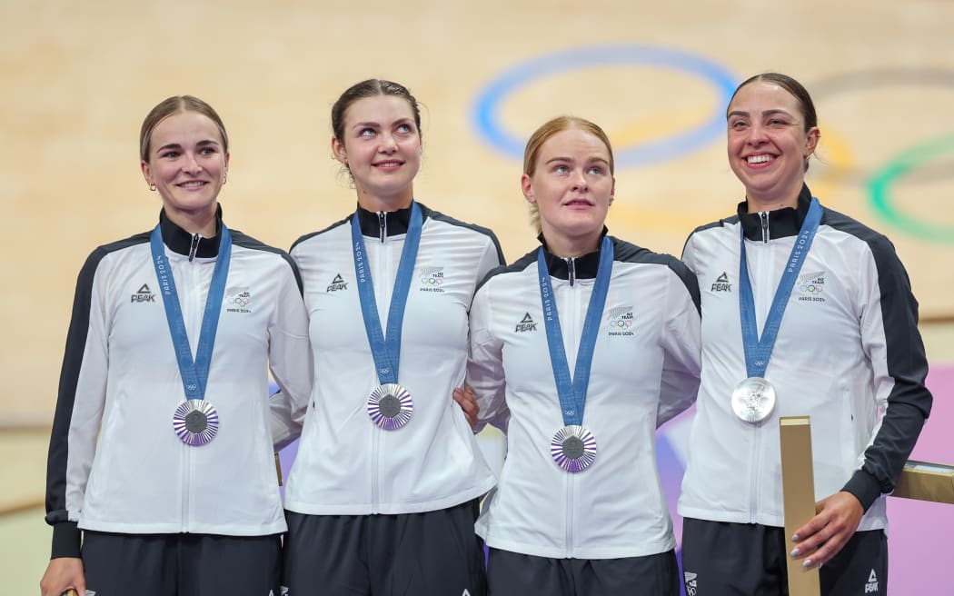 Picture by Alex Whitehead/SWpix.com - 07/08/2024 -  Paris 2024 Olympic Games - Track Cycling - National Velodrome, Saint-Quentin-en-Yvelines, France - Women’s Team Pursuit - Ally Wollaston, Bryony Botha, Emily Shearman, Nicole Shields (New Zealand) on the podium receiving the Olympic Silver Medal