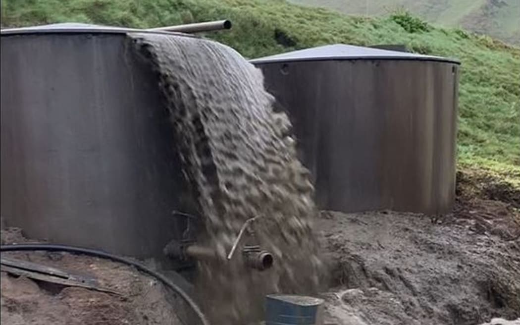 A screenshot of a video taken by Waikato Regional Council staff on 2 August 2023 shows effluent overflowing from a holding tank into a stream north of Te Aroha.