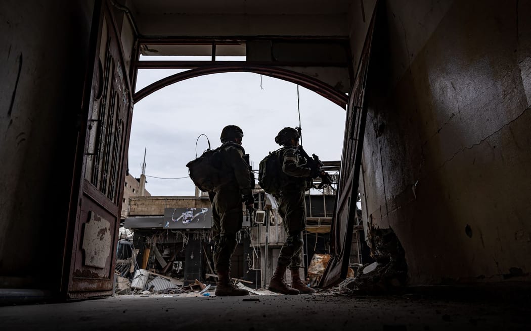 This handout picture released by the Israeli army on February 29, 2024 shows Israeli army soldiers in an unspecified location in the Gaza Strip amid ongoing battles between Israel and the Palestinian militant group Hamas. (Photo by Israeli Army / AFP) / === RESTRICTED TO EDITORIAL USE - MANDATORY CREDIT "AFP PHOTO / Handout / Israeli Army' - NO MARKETING NO ADVERTISING CAMPAIGNS - DISTRIBUTED AS A SERVICE TO CLIENTS ==