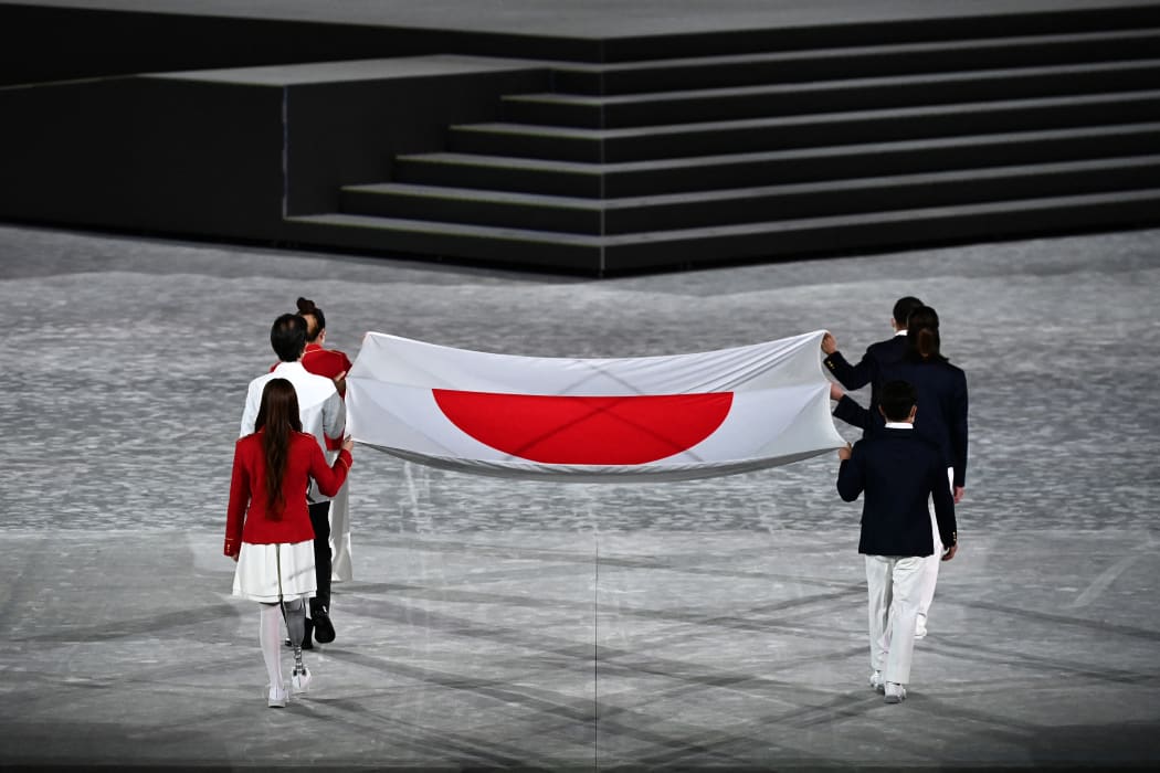 The Olympic flag is carried during the closing ceremony of the Tokyo 2020 Olympic Games, at the Olympic Stadium, in Tokyo.