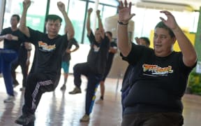 exercise programme at hospital in Bangkok. Dozens of sweaty  cops exercise to  pop songs as part of a scheme to reduce the number of overweight police in Bangkok.