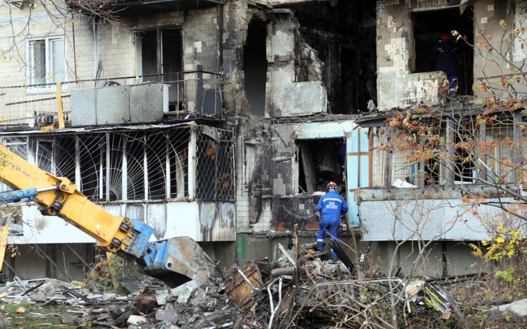 A rescuer stands on the pile of rubble at an apartment block in the Desnianskyi district hit by a Russian drone in Kyiv, Ukraine, on October 26, 2025. Russian drones attack Kyiv on the night of October 25-26. As reported, 32 people sustain injuries, including seven children, and three people are killed.