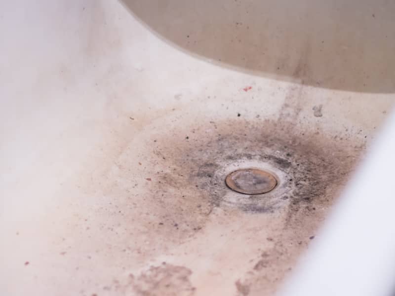 A clogged dirty drain in the bathroom for water