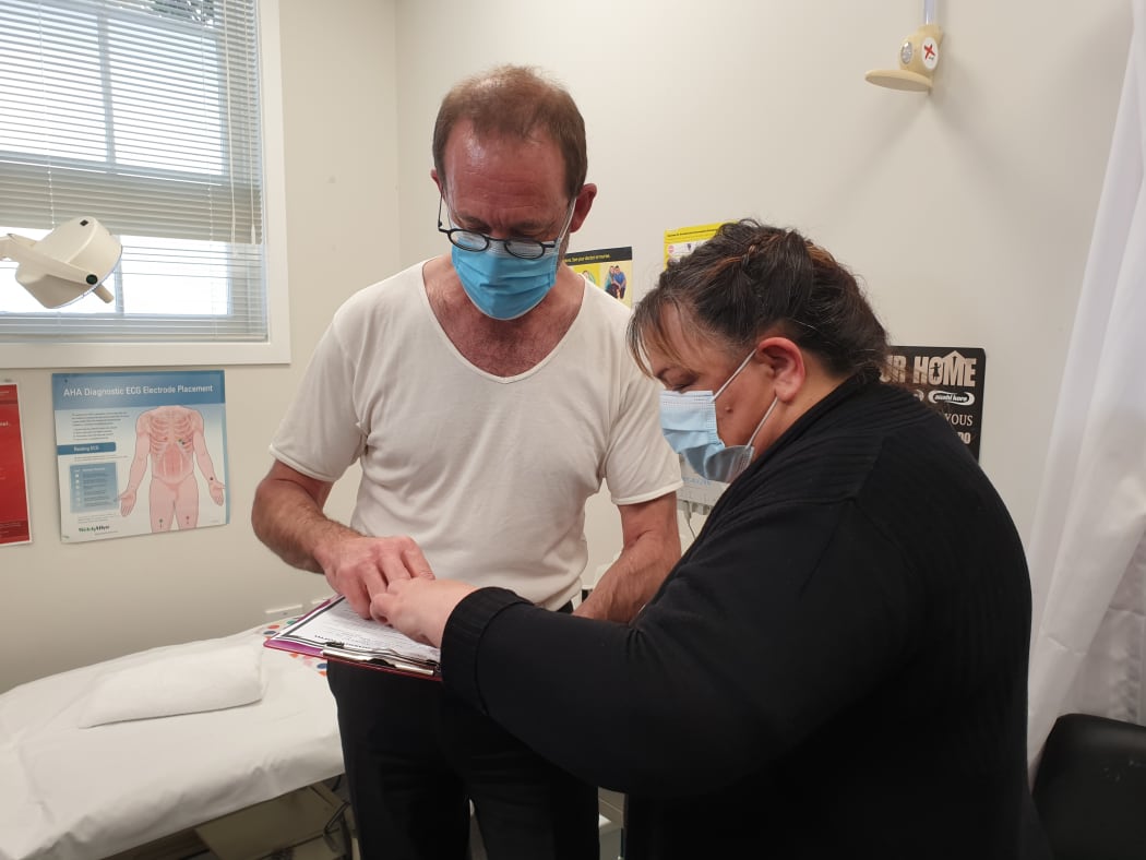 Minister of Health Andrew Little preparing to receive his flu vaccine.