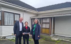 Nelson City Councillor Rachel Sanson Nelson Tasman Housing Trust director Carrie Mozena and Nelson mayor Nick Smith outside the Waimea Road property that will be demolished