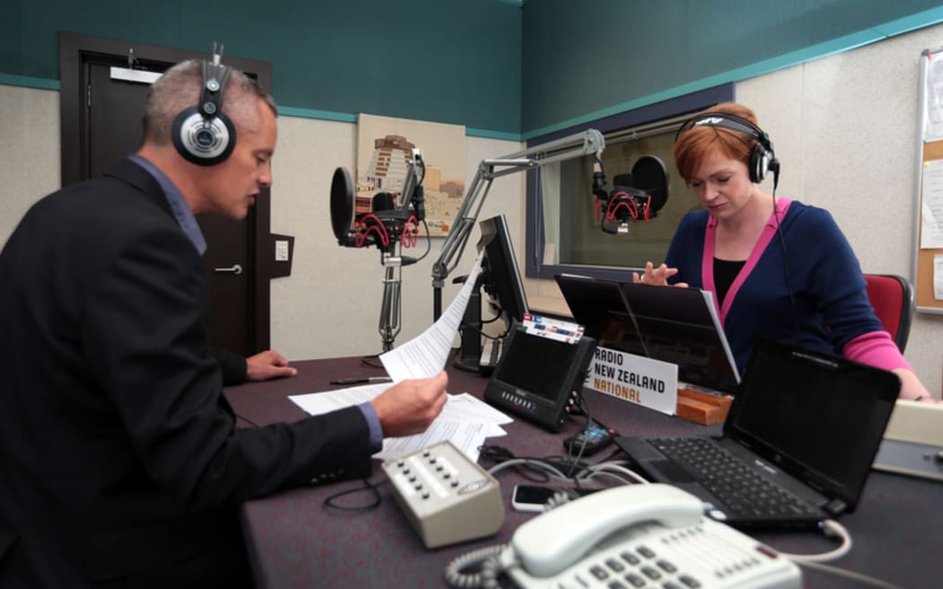 260314. Photo Diego Opatowski / RNZ. Guyon Espiner and Susie Ferguson at the Morning Report studio, Radio NZ.