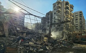 Rubble of destroyed buildings is pictured at the site of an Israeli airstrike that targeted Rweiss neighbourhood in Beirut's southern suburbs, on March 8, 2026. AFPTV footage showed smoke billowing over the southern suburbs of Beirut on March 8 following an apparent air strike on the area where Lebanese militant group Hezbollah holds sway. Several hours earlier, the Israeli military said it had launched strikes on "Hezbollah infrastructure" in that area. (Photo by AFP)
