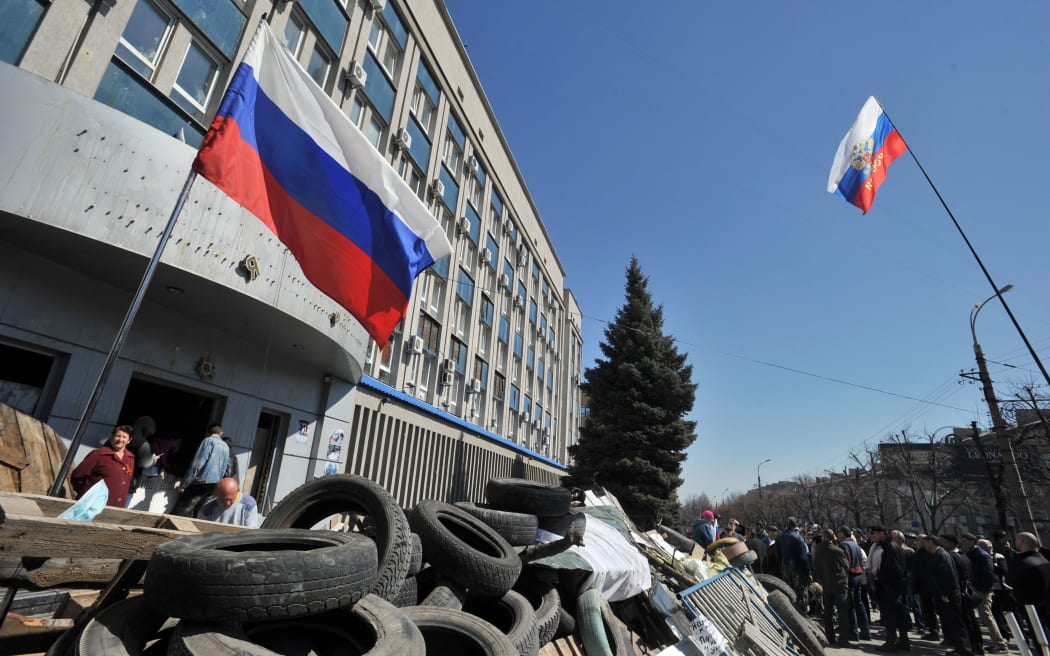 Pro-Russian activists blockade access to the Ukrainian Security Service building in the eastern Ukrainian city of Luhansk.