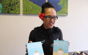 Palau's ambassador to the United Nations Olai Uludong with copies of the children's book by Toni Soalablai.