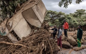 Young men inspect a destroyed car carried by waters in an area heavily affected by torrential rains and flash floods in the village of Kamuchiri, near Mai Mahiu, on April 29, 2024. At least 45 people died when a dam burst its banks near a town in Kenya's Rift Valley, police said on April 29, 2024, as torrential rains and floods battered the country.
The disaster raises the total death toll over the March-May wet season in Kenya to more than 120 as heavier than usual rainfall pounds East Africa, compounded by the El Nino weather pattern. (Photo by LUIS TATO / AFP)