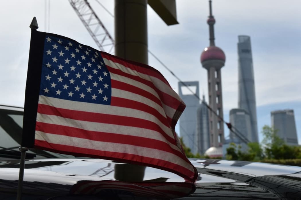 A US flag flying on a US consulate car with the backdrop of buildings in the Lujiazui financial district in Shanghai.