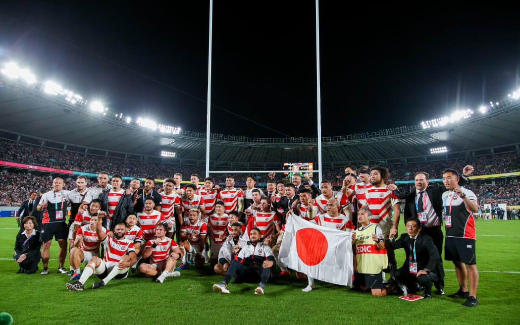 Japan team pose for a photo after the 2019 Rugby World Cup quarter-final match between Japan and South Africa at Tokyo Stadium