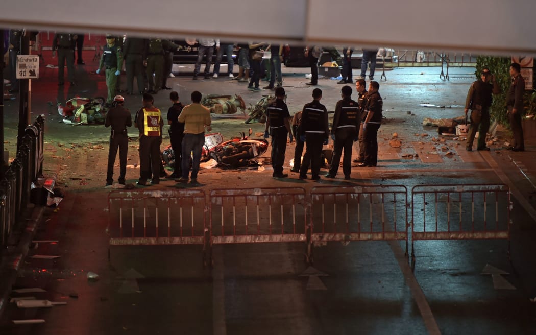Thai soldiers and police inspect at the scene after a bomb exploded outside a religious shrine in central Bangkok late on August 17, 2015.