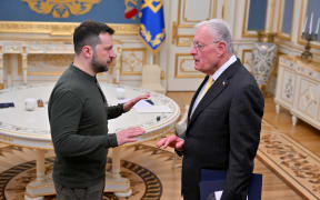 Ukraine's President Volodymyr Zelensky (L) greets US special envoy for Ukraine Keith Kellogg at his offices in Kyiv on February 20, 2025, amid the Russian invasion of Ukraine. Zelensky meets with US envoy Kellogg after the US president branded the Ukrainian leader a "dictator" and said Russia "have the cards" in any talks to end the war. The United States has provided essential funding and arms to Ukraine, but the US president has rattled Kyiv and its European backers by opening talks with Moscow they fear could end the war on terms unacceptable to them. (Photo by Sergei SUPINSKY / AFP)