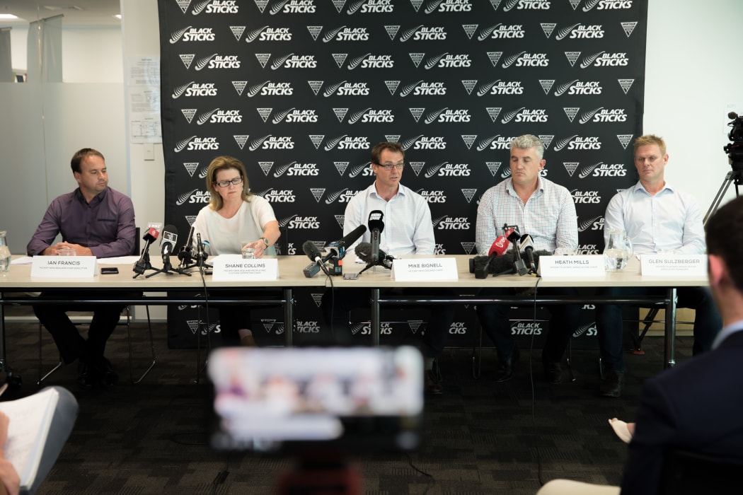 Hockey New Zealand chief executive Mike Bignell (center) speaks to media at a press conference.