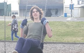 Charlie O'Brien, at Taradale playground, tries to break the world record for swinging the longest period of time.
