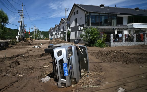A flood damaged car is seen following heavy rains in Huairou district, on the outskirts of Beijing.
