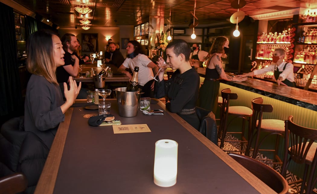 Patrons enjoy a drink in Nick & Nora's bar at a midnight opening in Melbourne on October 28, 2020 after the state government lifted some of the city's harsh restrictions.
