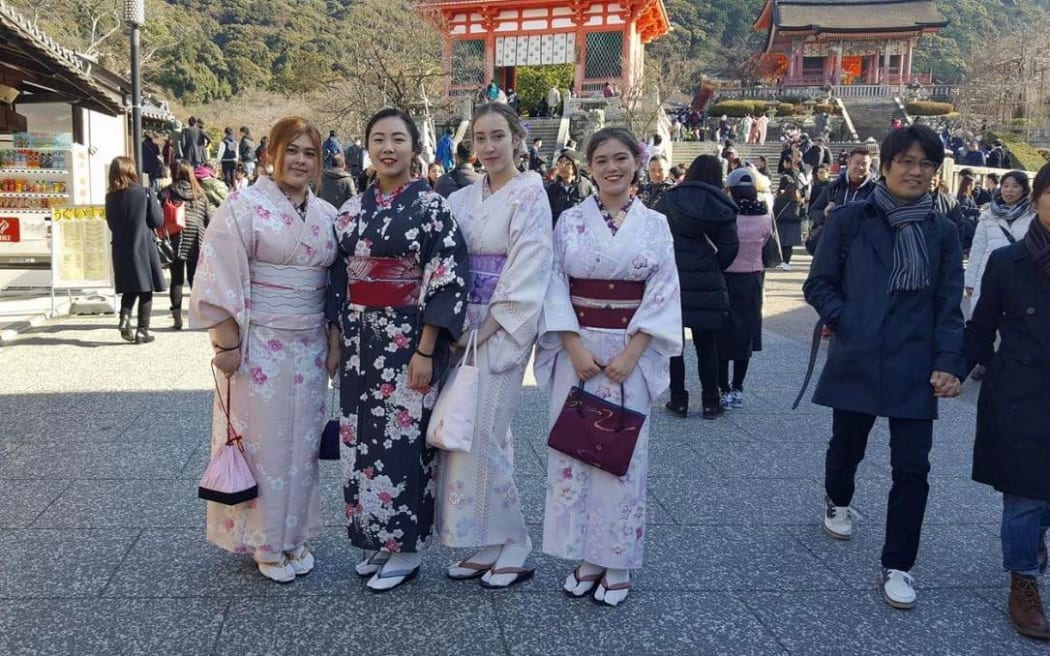 Four people wearing kimonos.