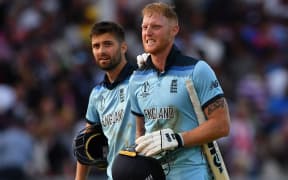 England's Ben Stokes (R) reacts in frustration as he loeaves the pitch with England's Mark Wood ahead of a 'super over' during the 2019 Cricket World Cup final between England and New Zealand at Lord's Cricket Ground July 14, 2019.