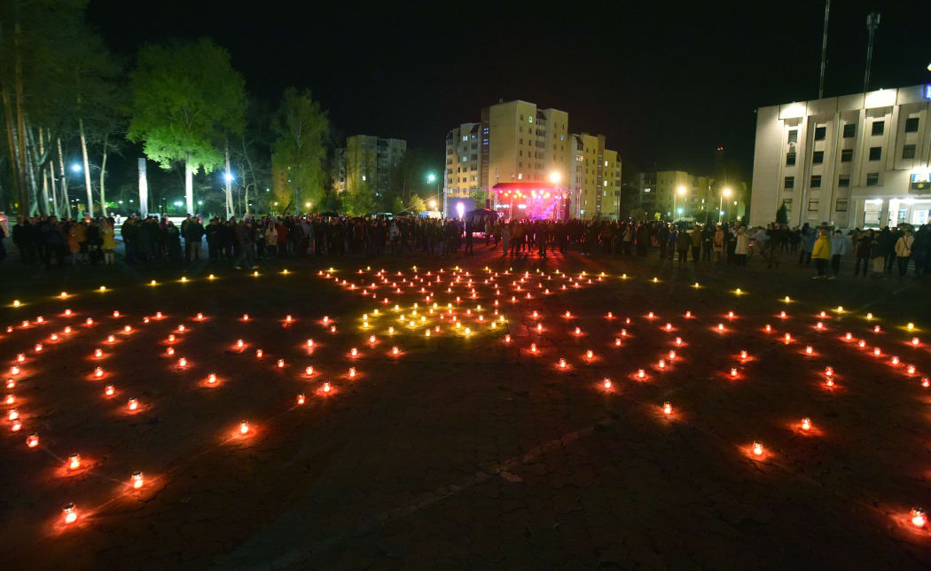 Candles are lit in the shape of a radiation hazard symbol on the 30th anniversary of the Chernobyl disaster.