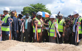 Papua New Guinea's Prime Minister James Marape (centre, brown suit) talks to New Ireland provincial Governor Sir Julius Chan at a groundbreaking ceremony for the upgrade of Kavieng airport, 16 July 2020.