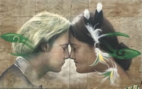 A mural of two school students performing a hongi.