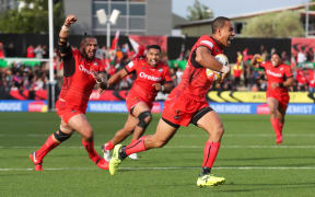 Team mates celebrate as Tonga's William Hopoate scores