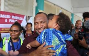 James Marape with two-year-old Herman Luk