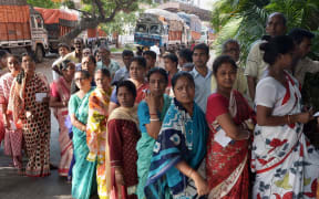 Voters waiting to cast their vote in Kolkata on Monday.