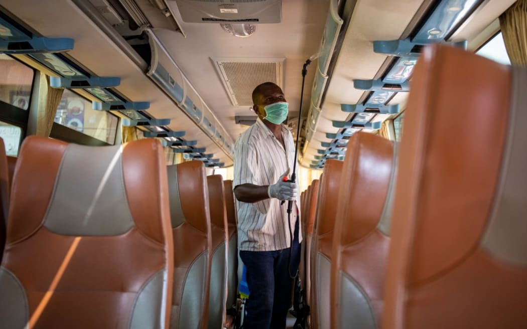 A worker of an intercity bus company disinfects the bus as a preventive measure against the spread of the COVID-19 coronavirus in Kampala, Uganda.